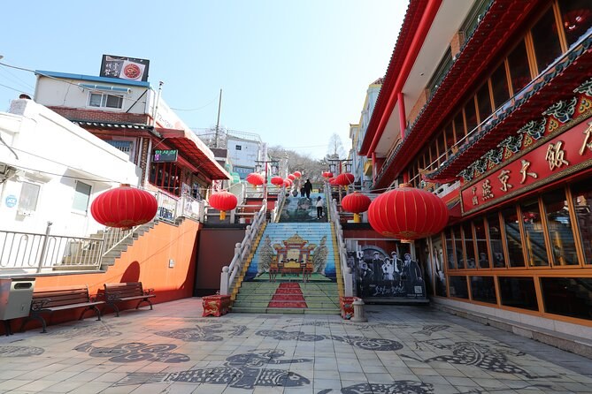 A covered market alley hung with red lanterns