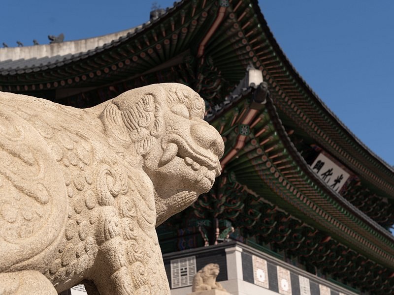 A haetae stone guardian carved at the foot of a palace staircase